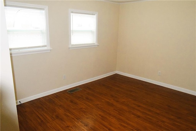 unfurnished room with dark hardwood / wood-style flooring