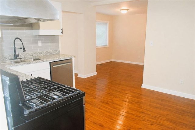 kitchen with range with gas cooktop, backsplash, dishwasher, sink, and white cabinetry