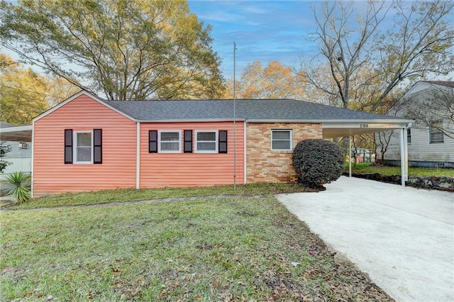 view of side of home with a carport and a yard