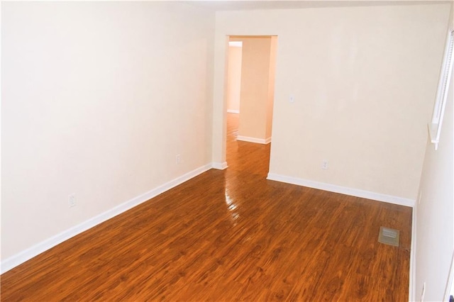 spare room with wood-type flooring