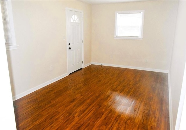 unfurnished room with dark hardwood / wood-style flooring