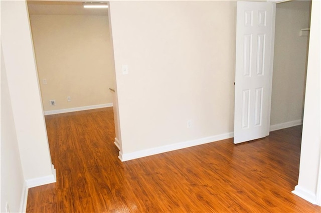 spare room featuring wood-type flooring