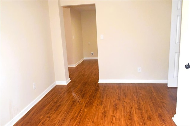 spare room featuring dark wood-type flooring