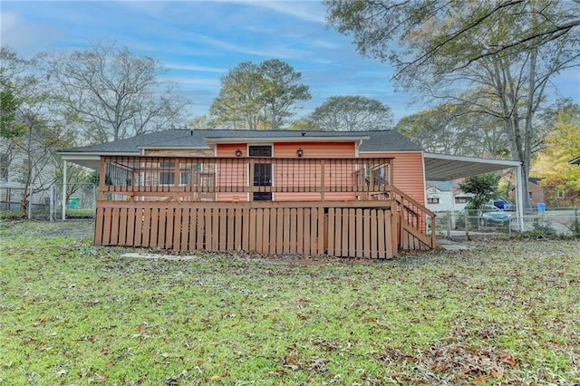 rear view of property featuring a wooden deck and a lawn