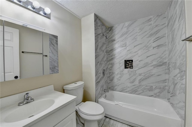 full bathroom featuring toilet, vanity, a textured ceiling, and tiled shower / bath