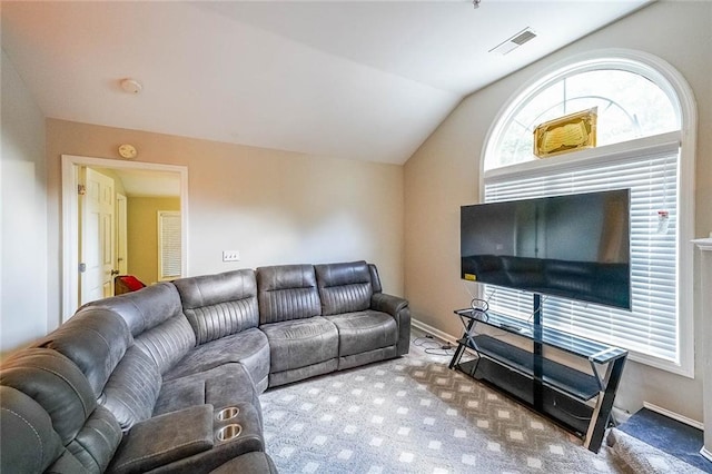 carpeted living room featuring visible vents, vaulted ceiling, and baseboards