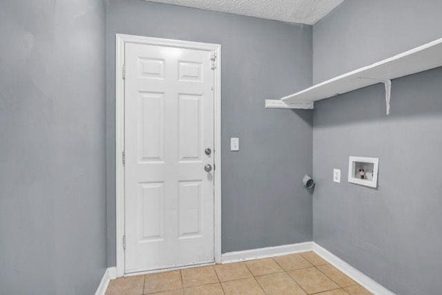 2505 Tiffany Ct SE, Conyers, GA 30013 - washroom with washer hookup, light tile patterned floors, baseboards, and a textured ceiling