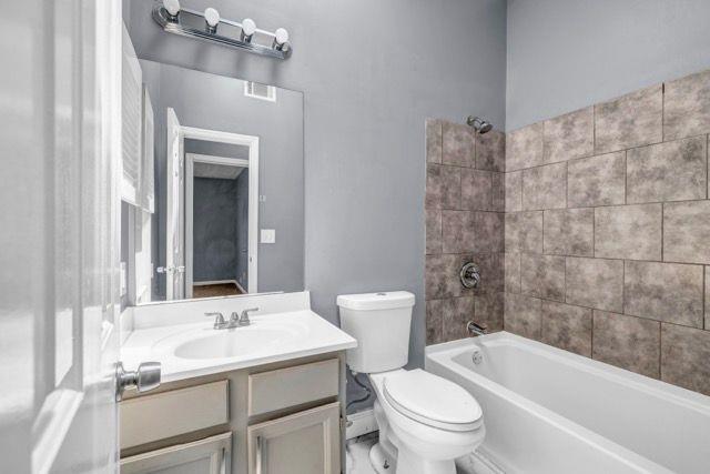 2505 Tiffany Ct SE, Conyers, GA 30013 - full bathroom with toilet, vanity, and bathing tub / shower combination