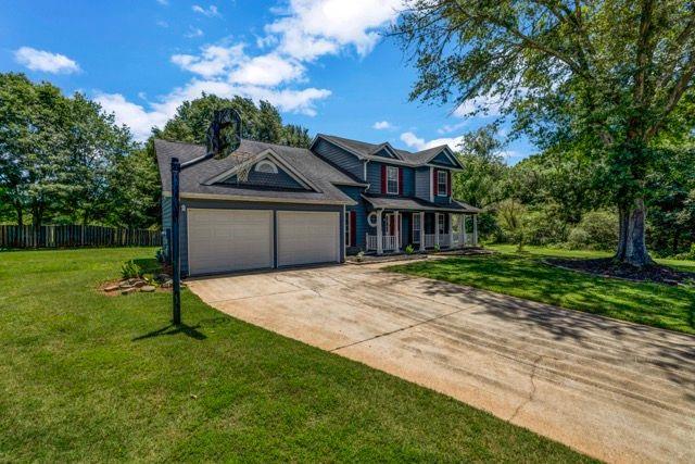 2505 Tiffany Ct SE, Conyers, GA 30013 - traditional-style house with a garage and concrete driveway