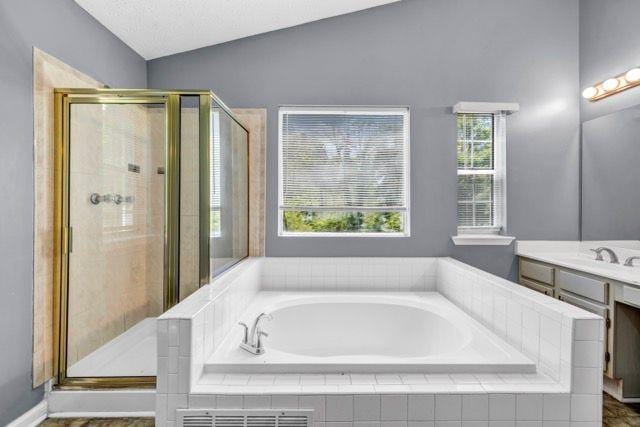 2505 Tiffany Ct SE, Conyers, GA 30013 - bathroom featuring vanity, a garden tub, a stall shower, and vaulted ceiling