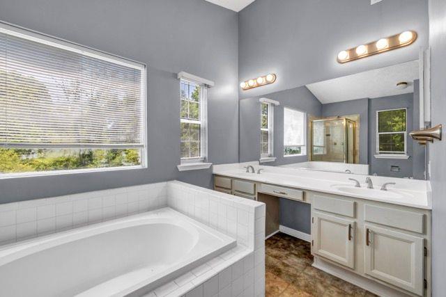 2505 Tiffany Ct SE, Conyers, GA 30013 - full bathroom featuring a garden tub, double vanity, a shower stall, and tile patterned floors