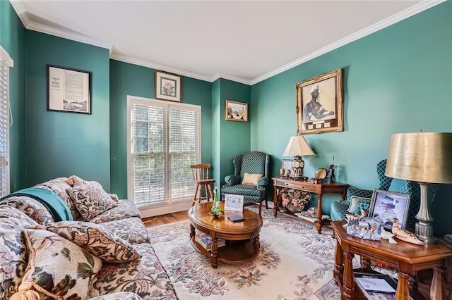 sitting room with hardwood / wood-style floors and crown molding