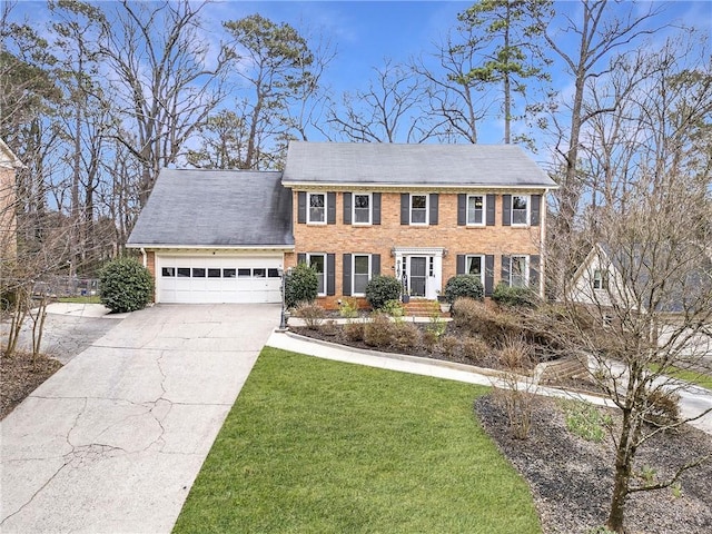 colonial house with brick siding, a front lawn, concrete driveway, and an attached garage