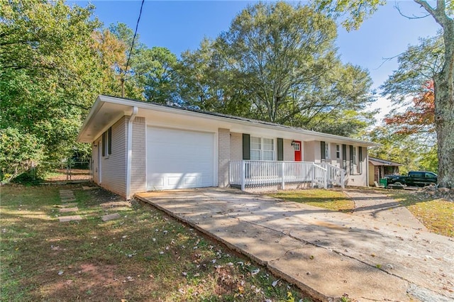 ranch-style house featuring a garage and covered porch