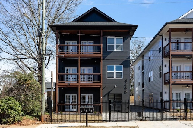 view of front of home featuring a fenced front yard and french doors