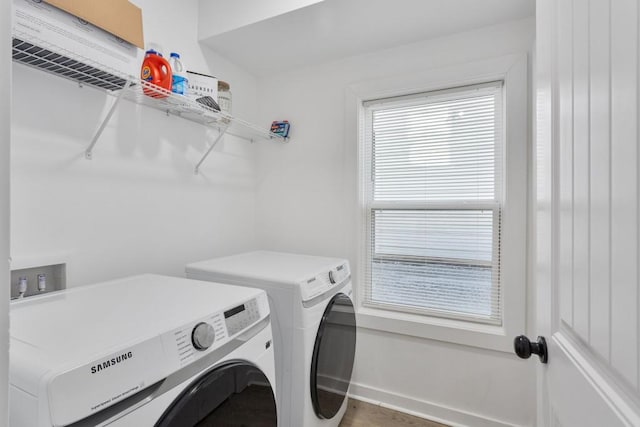 washroom with laundry area, baseboards, and washer and clothes dryer