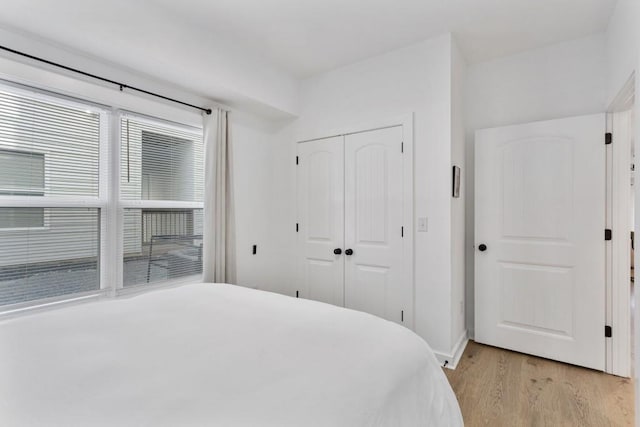 bedroom featuring a closet and light wood-style flooring