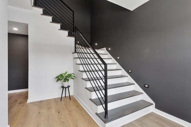 stairs with baseboards and wood finished floors