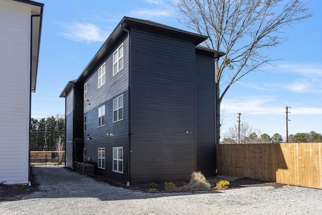 view of side of home featuring fence