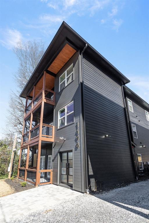 exterior space with driveway and a balcony