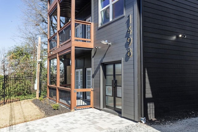 exterior space featuring a balcony and fence