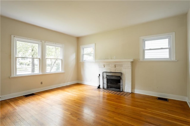 153 Hood Cir, Decatur, GA 30030 - unfurnished living room featuring wood finished floors, baseboards, a fireplace, and visible vents
