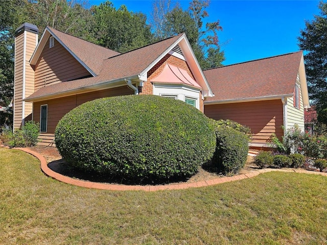 view of home's exterior featuring a yard