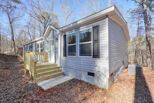 view of side of home featuring central AC