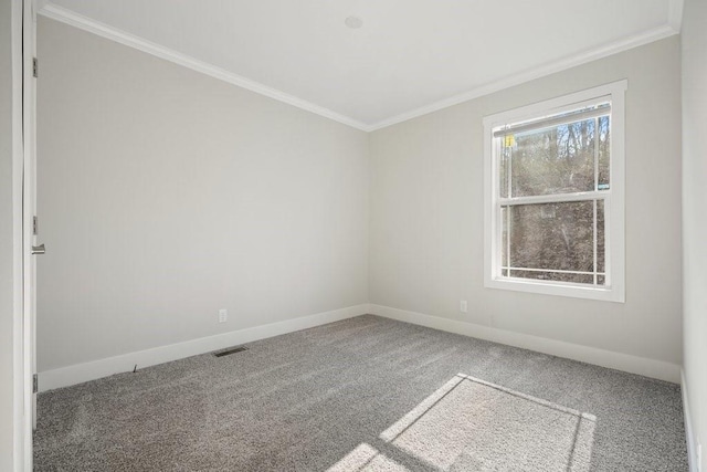 empty room with ornamental molding and carpet