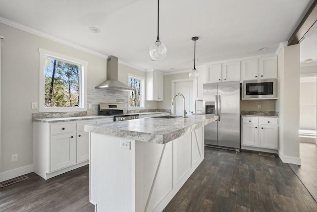 kitchen featuring white cabinets, stainless steel appliances, sink, a center island with sink, and range hood