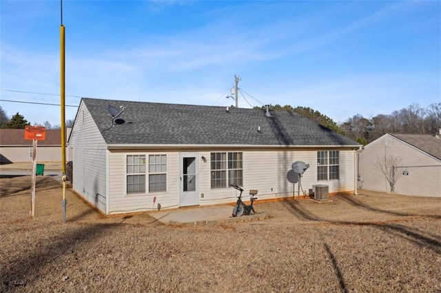 rear view of property with a yard, a patio area, and central air condition unit