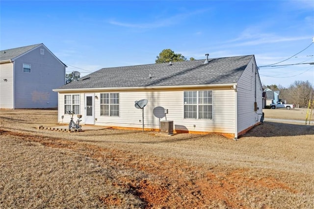 rear view of property with a patio and a lawn