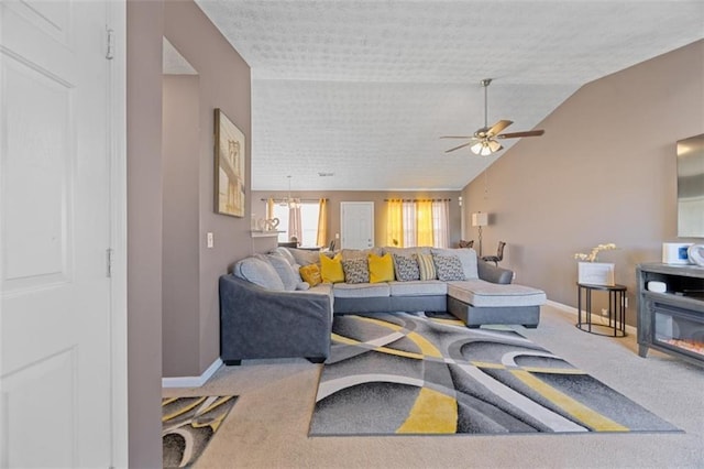 living room featuring ceiling fan with notable chandelier, vaulted ceiling, and carpet flooring