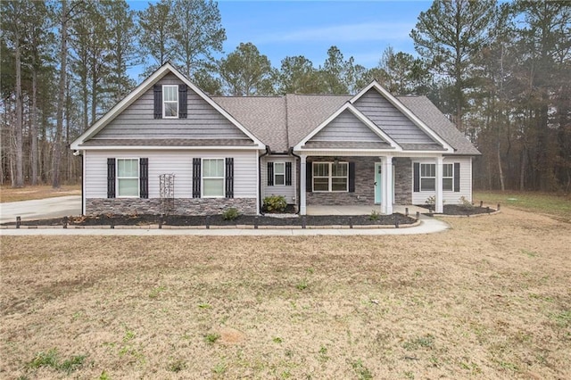 view of front of property featuring covered porch and a front yard