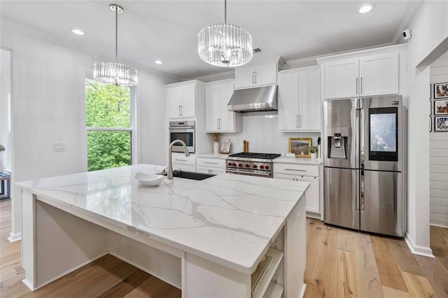 kitchen with a sink, stainless steel appliances, a chandelier, and under cabinet range hood