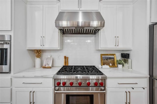 kitchen with range hood, backsplash, stainless steel appliances, and white cabinets