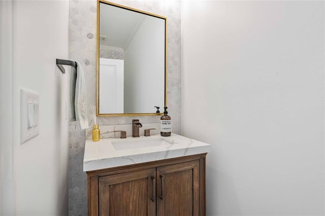 bathroom featuring ornamental molding and vanity