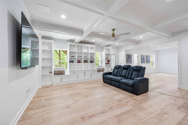 living room featuring ceiling fan, light wood finished floors, plenty of natural light, beamed ceiling, and coffered ceiling