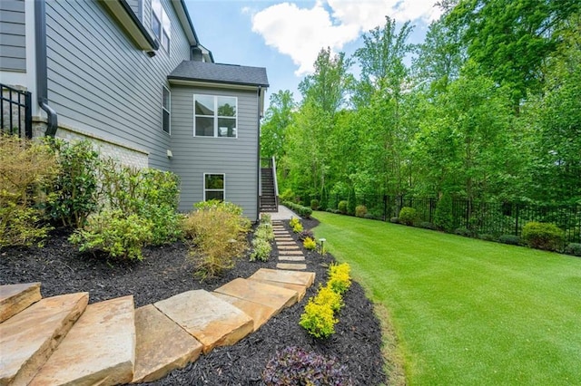 view of yard featuring stairway and fence