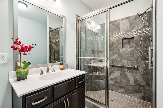 bathroom with vanity and a shower stall