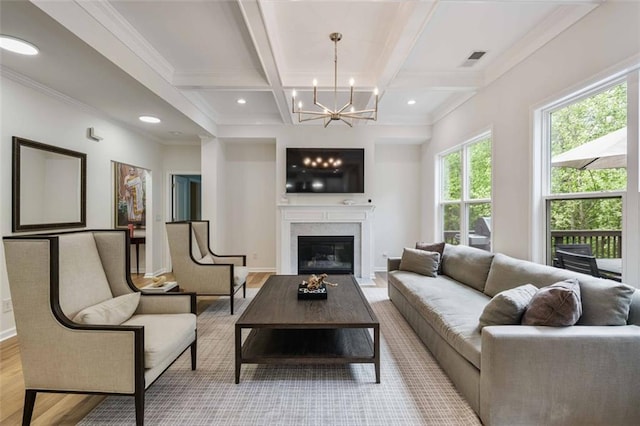 living room featuring visible vents, beam ceiling, wood finished floors, an inviting chandelier, and coffered ceiling