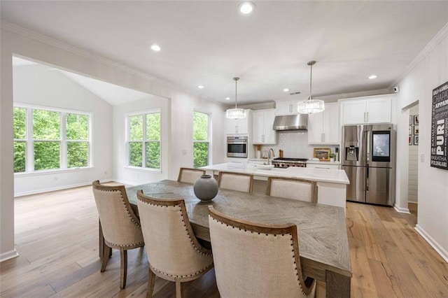 dining area with crown molding, recessed lighting, baseboards, and light wood-style flooring