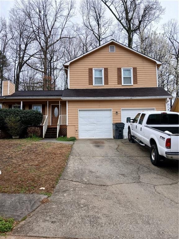 split level home featuring an attached garage and driveway