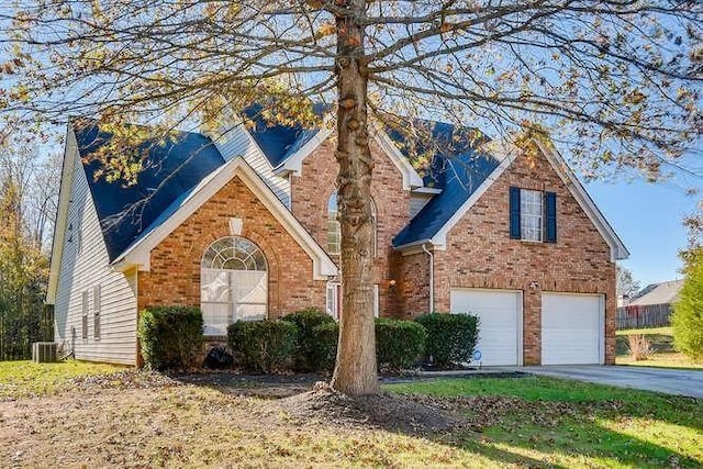 view of property featuring central AC unit and a garage