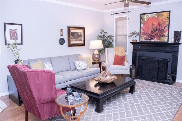 living room with wood-type flooring, ceiling fan, and crown molding