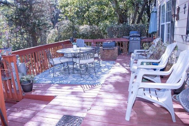 wooden terrace with a grill