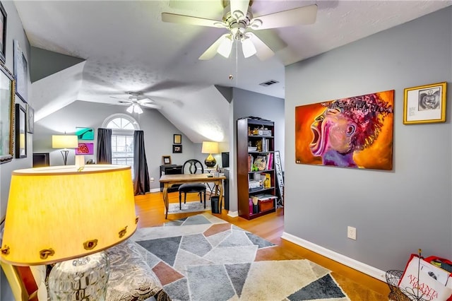 office space featuring ceiling fan, light hardwood / wood-style floors, and lofted ceiling