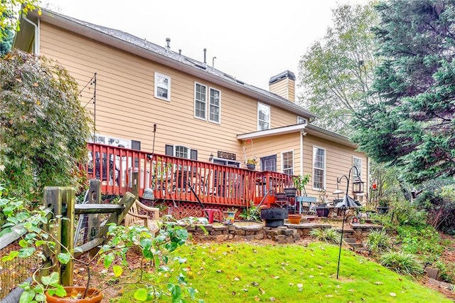 back of property featuring a lawn and a wooden deck