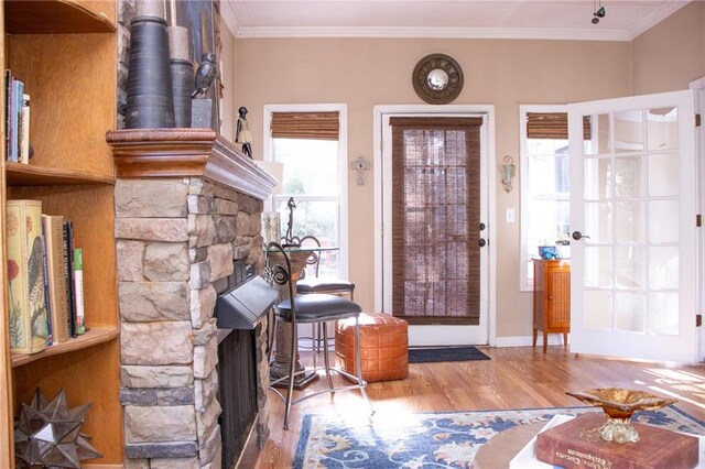 foyer entrance featuring crown molding and wood-type flooring