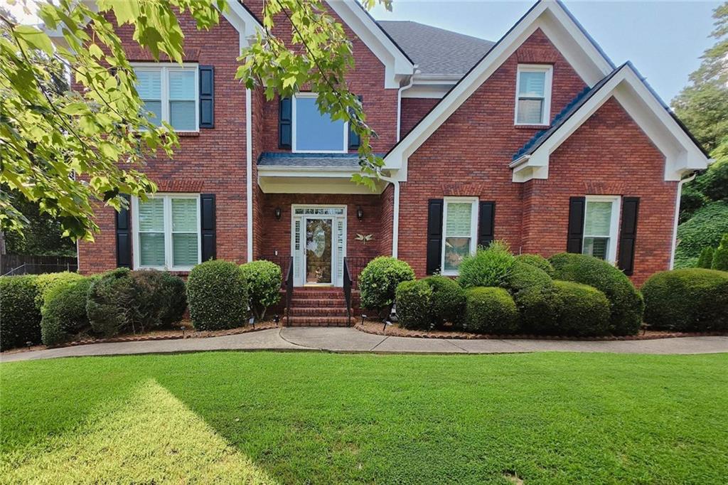 1205 Runnelwood Trl, Snellville, GA 30078 - traditional home with a front yard and brick siding